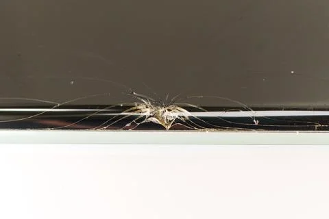 Cracked glass with spider web pattern in a modern setting 스톡 사진