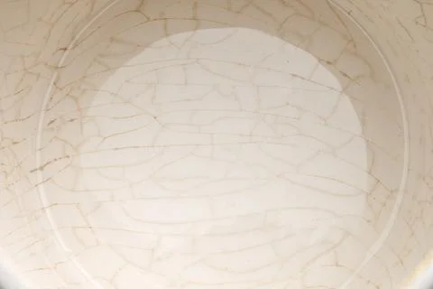 Cracked glaze on the bottom of a white ceramic cup Stock Photos
