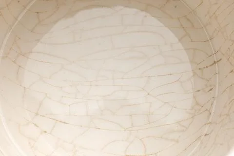 Cracked glaze on the bottom of a white ceramic cup 库存照片