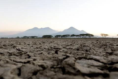 Cracked ground blurred mountain background Foto stock
