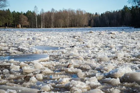 Cracked ice floating springtime on blue water mountain lake Stock Photos