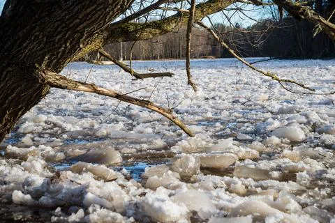 Cracked ice floating springtime on blue water mountain lake Stock Photos
