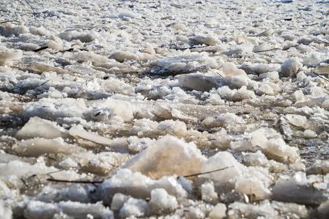 Cracked ice floating springtime on blue water mountain lake Stock Photos