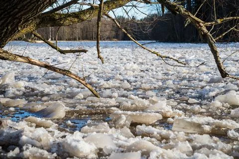 Cracked ice floating springtime on blue water mountain lake Stock Photos
