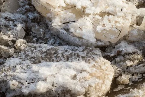 Cracked ice floating springtime on blue water mountain lake Stock Photos