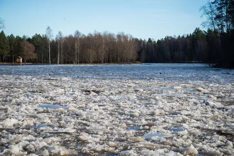 Cracked ice floating springtime on blue water mountain lake Stock Photos