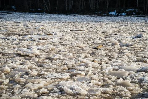 Cracked ice floating springtime on blue water mountain lake Stock Photos