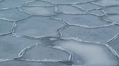 Cracked Ice Forms Natural Geometric Patterns Across Frozen Winter Water Surface Stock Footage 346266509