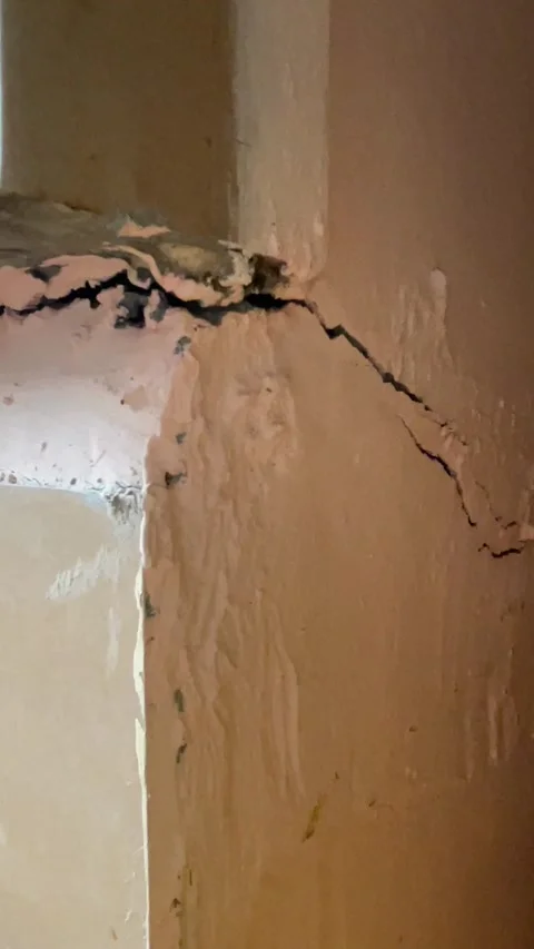 Cracked Interior Wall and Roughly Patched Kitchen Counter Base Stock Footage 321178685