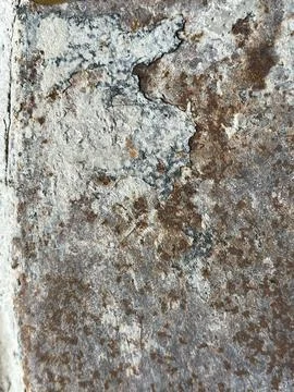 Cracked old concrete wall with rusty metal stains and peeling paint Stock Photos