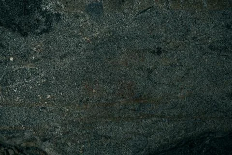 Cracked old stone wall background, dark grunge texture close up Stock Photos