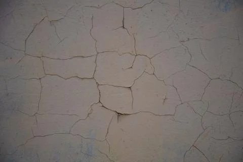 Cracked plaster structure. Background, texture. Neutral beige color. Stock Photos