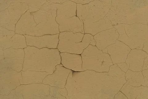 Cracked plaster structure. Background, texture. Neutral beige color. Stock Photos