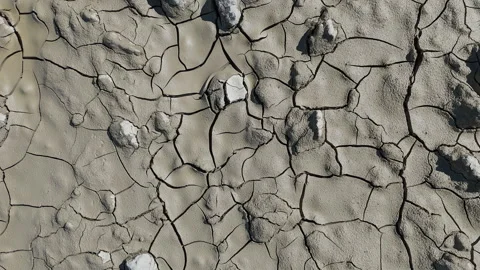 Cracked post-flood mud, close-up shot from a drone Stock Footage 287483181