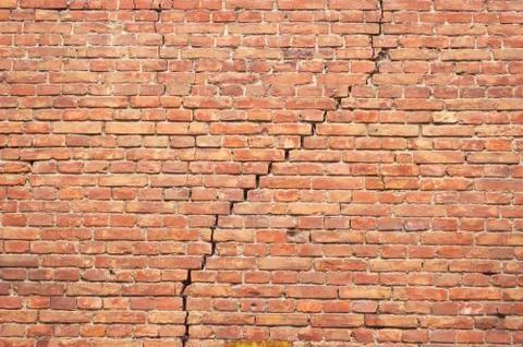 Cracked red brick wall texture. grunge background. Stock Photos