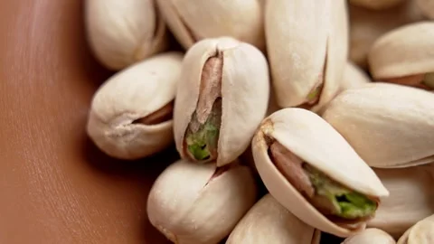 Cracked roasted pistachio nuts with green kernels Stock Footage 331343347