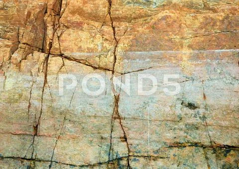 Cracked rock on seacoast backdrop Stock Photos