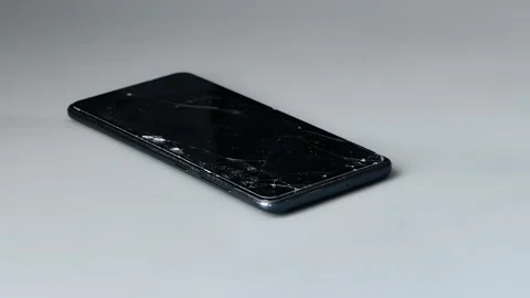 Cracked screen protector for smartphone. Damaged mobile phone with shattered Stock Footage 344846575