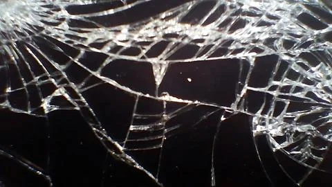 Cracked smartphone screen display with sharp white lines and patterns Stock Photos