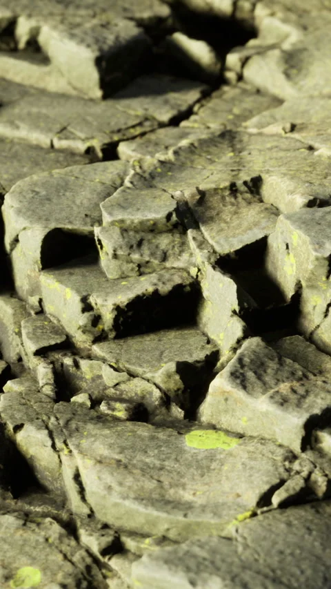 Cracked stone surface showing natural texture in bright light Stock Footage 334188002