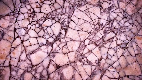 A cracked stone texture featuring soft pink, purple, and beige tones, offer.. Illustration