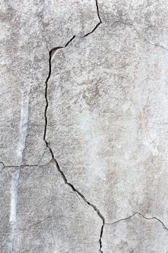 Cracked stone wall background Stock Photos