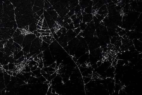 Cracked surface with intricate web-like patterns on a dark background, show.. Stock Photos