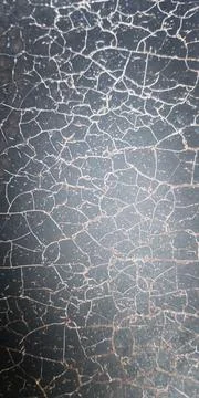 Cracked surface showing texture and patterns in a close-up view Stock-Fotos