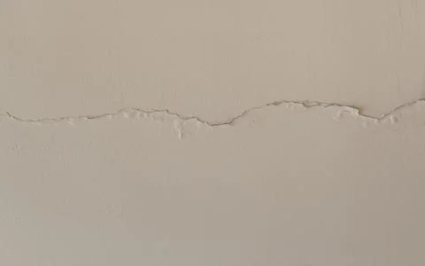 Cracked wall background. Off-white stucco wall. Stock Photos