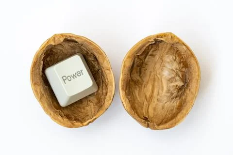 Cracked walnut shell with a computer POWER button Stock Photos