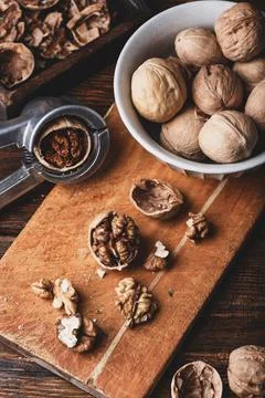 Cracked walnuts and nutcracker Stock Photos