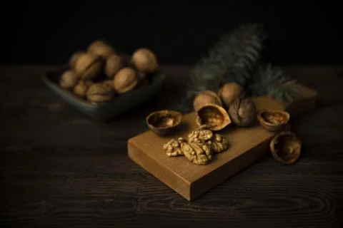 Cracked walnuts and walnut kernels on wooden background Stock Photos