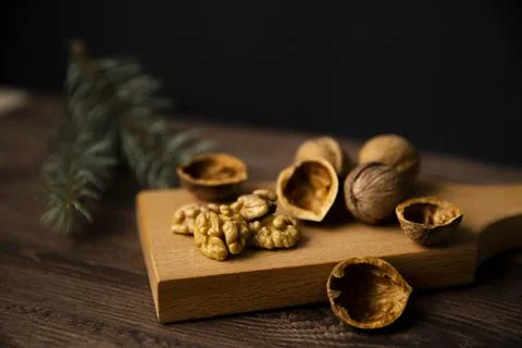 Cracked walnuts and walnut kernels on wooden background Stock Photos