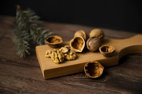 Cracked walnuts and walnut kernels on wooden background Stock Photos