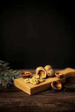 Cracked walnuts and walnut kernels on wooden background Stock Photos