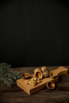 Cracked walnuts and walnut kernels on wooden background Stock Photos