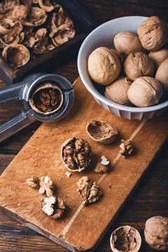 Cracked walnuts on cutting board Stock Photos