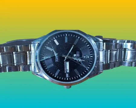 Cracked watch on multi-colored background 1 Stock Photos