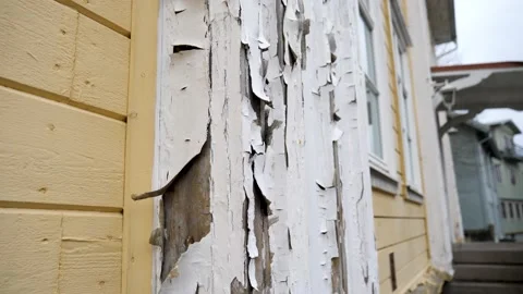 Cracked white paint peeling off wall Stock Footage