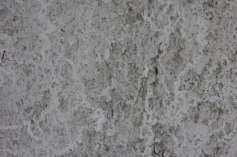 Cracked white painted surface with gray stains creating an aged grunge text.. Stockfoto's