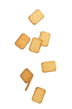 Cracker cookies falling isolated on white background with clipping path Stock Photos