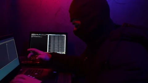 Cracker in a mask will break the computer. Theft of digital data Stock Footage 124360794