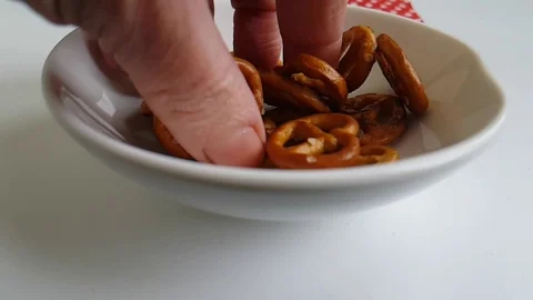Cracker salty on a white background hand, slow-motion shot Video stock 87954088