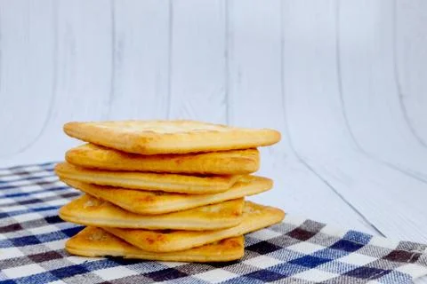 Cracker squares stacked, Cracker squares stacked on plaid fabric, Cracker squ Stock Photos