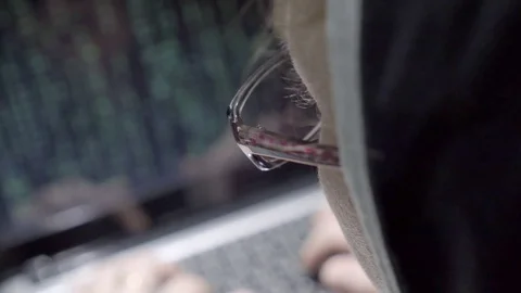 Cracker works with his hands on the computer keyboard. Stock-Footage 76840343