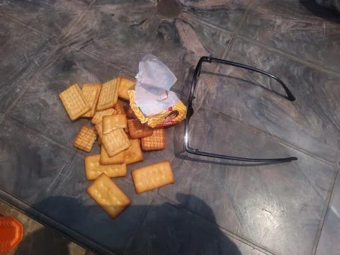 Crackers and glasses on gray surface. Stock Photos