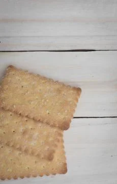 Crackers isolated on wooden table Stock Photos