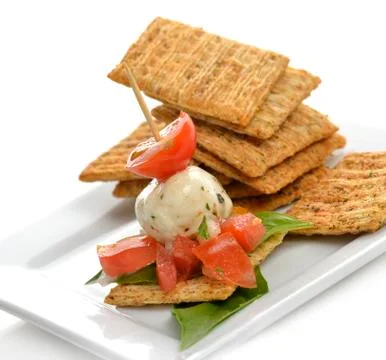 Crackers with mozzarella and tomatoes Stock Photos