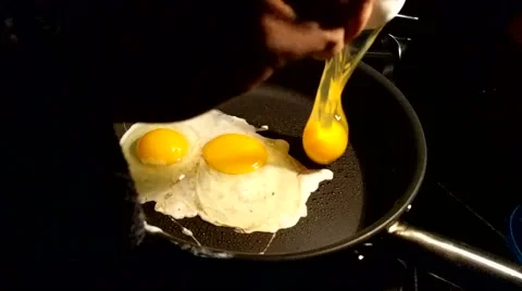 Cracking and Frying an Egg Slow Motion Stock Footage 56930618