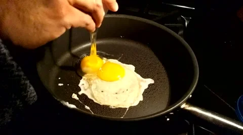 Cracking and Frying an Egg Slow Motion Stock Footage 56930690